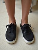 pikaso_texttoimage_photo-of-a-womans-feet-wearing-black-Keds-sneakers-2.jpeg