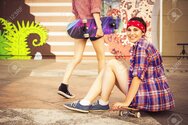 99098955-two-brunette-teenage-girls-friends-in-hipster-outfit-jeans-shorts-keds-plaid-shirt-hat-.jpg