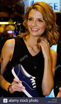 actress-misch-barton-holds-a-keds-shoe-on-the-floor-of-the-new-york-stock-exchange-after-barton-.jpg