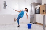 88554120-woman-janitor-slipping-while-mopping-floor-in-kitchen-at-home.jpg