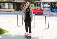 business-woman-riding-skateboard-city-attractive-stylish-young-talking-her-mobile-phone-118141...JPG