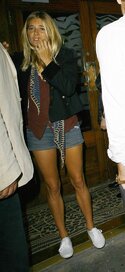 sienna_miller_brown_shirt_black_jacket_blue_denim_shorts.jpg